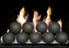 Fireplace with flames and grey ceramic spheres.