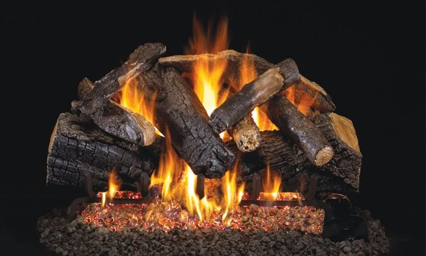 Fireplace with burning logs and orange flames. Dark logs on bed of embers.