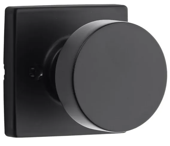 Black door knob with a round handle and square backplate.