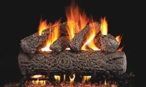 Burning fireplace gas logs with orange flames.
