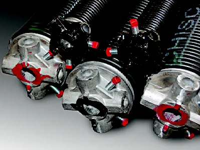 Close-up of three garage door torsion springs with silver winding cones and black coil springs again…