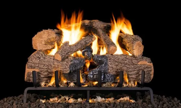 Burning gas fireplace logs with flames, in a black setting.
