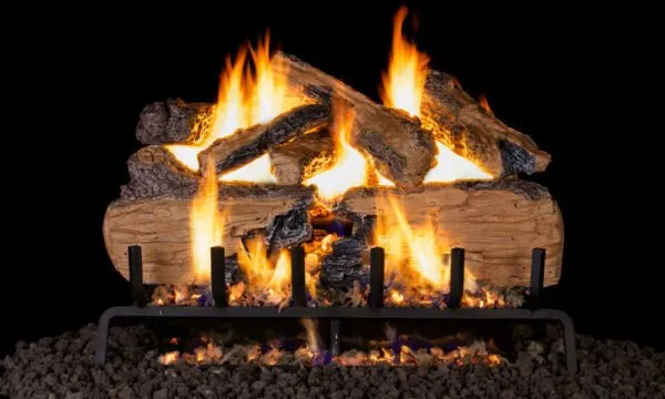 Fireplace with burning logs, flames, and a metal grate on a bed of dark rocks.