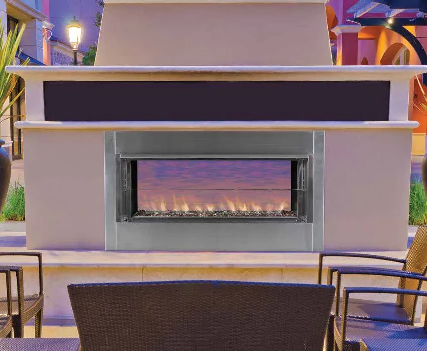 A modern outdoor fireplace with a linear flame display set into a neutral stone structure, surrounded by patio seating.