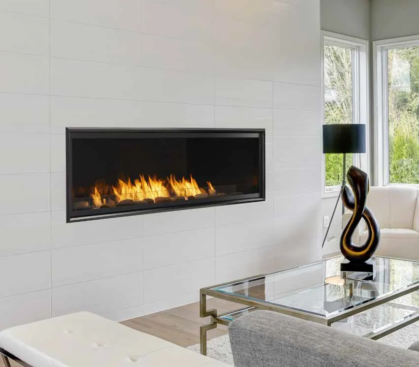 Modern living room with fireplace, white walls, and glass coffee table.