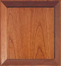 Wooden cabinet door with medium brown center panel and darker brown frame.
